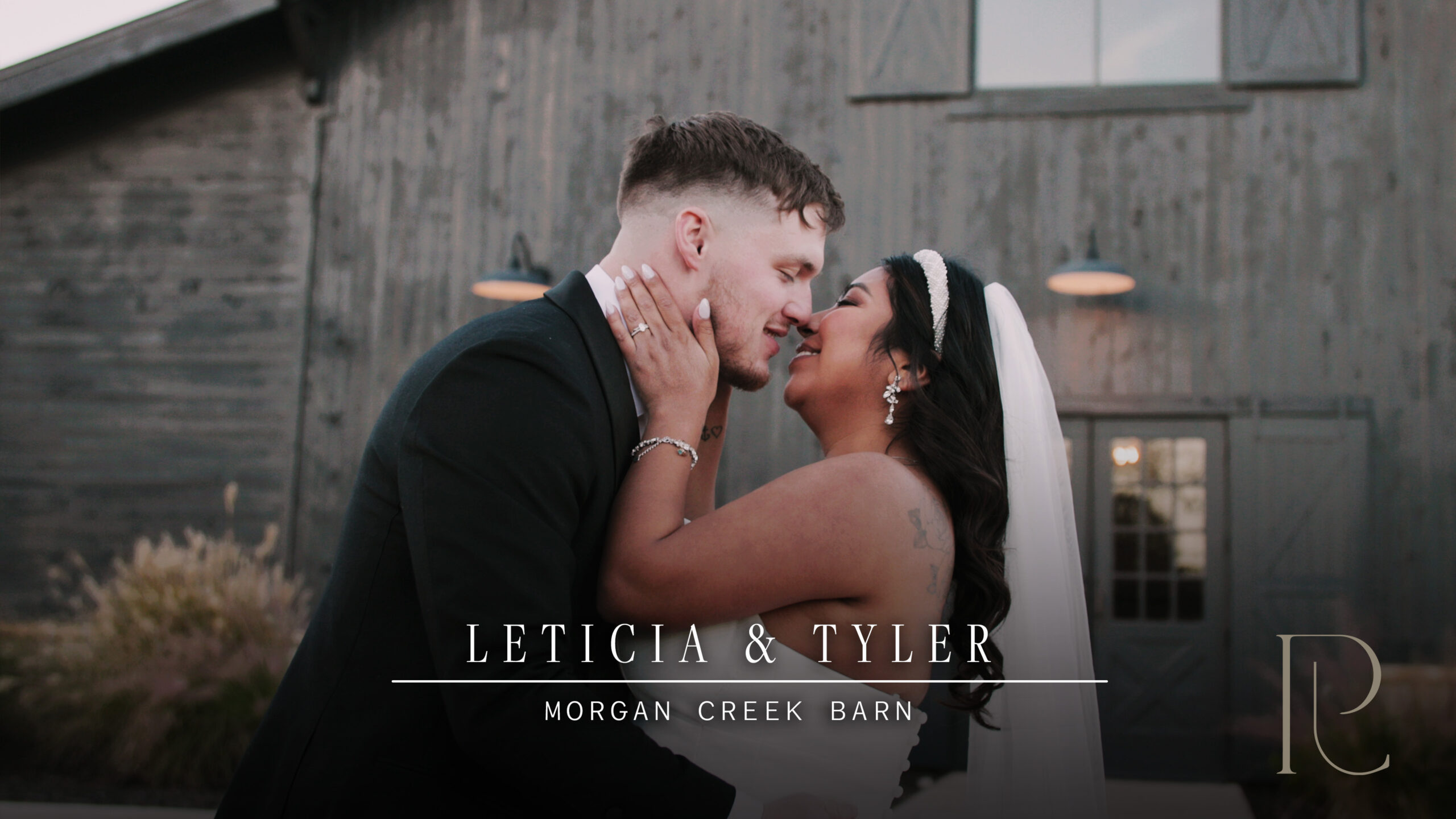 Leticia and Tyler kissing on their wedding day in front of Morgan Creek Barn